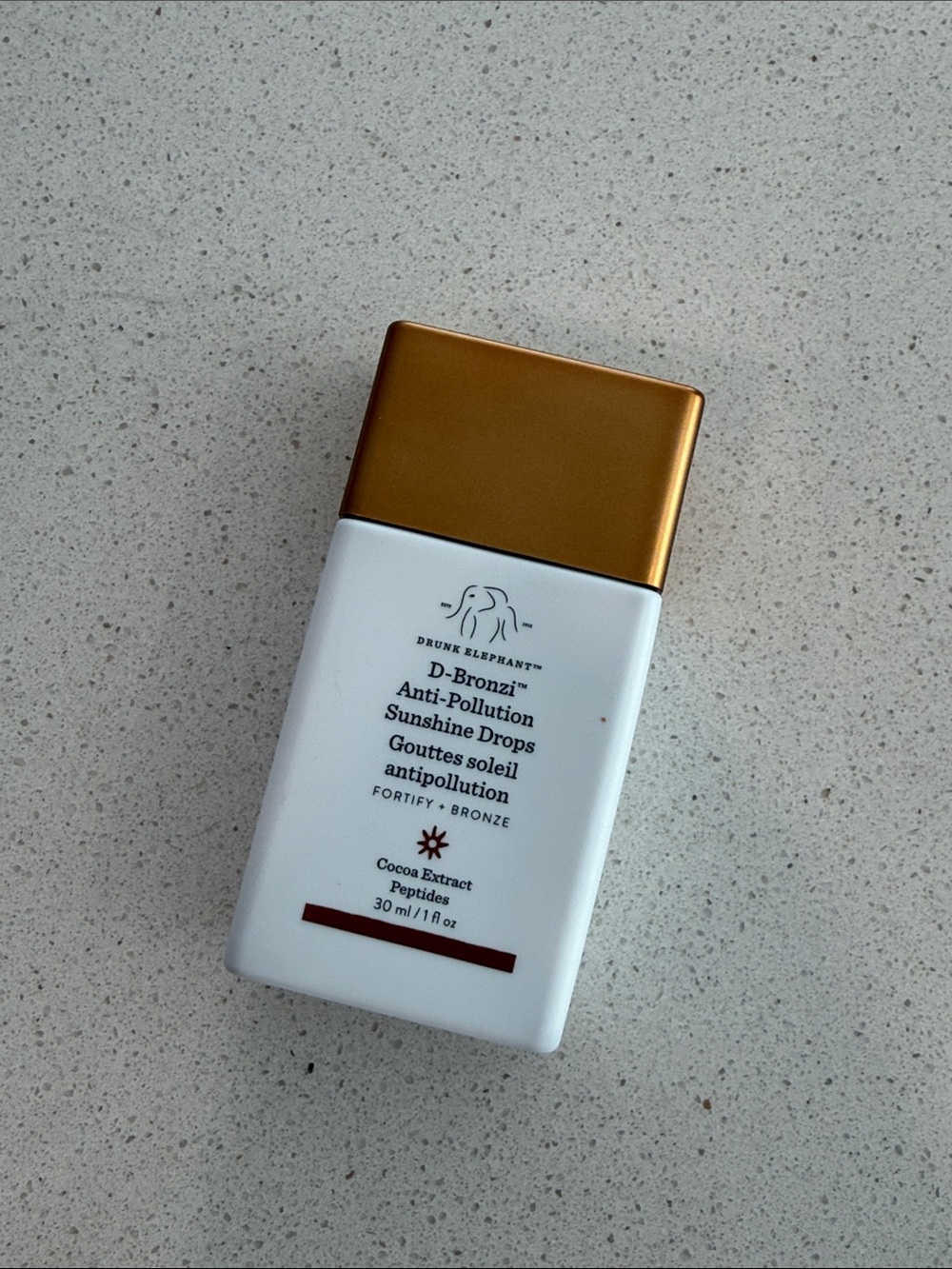Drunk Elephant Sunscreen-Style D-Bronzi Bottle in White and Gold